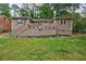 Charming home with a spacious backyard, a raised patio, and mature trees at 1304 Anchor Sw Ter, Atlanta, GA 30311