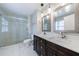 Bathroom featuring double sinks, a walk-in shower, and modern light fixtures at 1304 Anchor Sw Ter, Atlanta, GA 30311