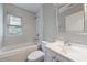 Updated bathroom features modern fixtures, hexagon tile, and soaking tub at 1304 Anchor Sw Ter, Atlanta, GA 30311