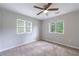 Carpeted bedroom with ceiling fan, and natural light from dual windows at 1304 Anchor Sw Ter, Atlanta, GA 30311