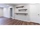Dining room with wood floors, three floating wood shelves and a door for extra storage at 1304 Anchor Sw Ter, Atlanta, GA 30311