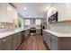 This kitchen features stainless steel appliances, designer backsplash, wood floors, and lots of natural light at 1304 Anchor Sw Ter, Atlanta, GA 30311