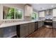 Bright kitchen with gray cabinets, stainless steel appliances, designer backsplash, and a view to the wooded yard at 1304 Anchor Sw Ter, Atlanta, GA 30311