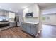 View of the kitchen featuring stainless steel appliances, designer backsplash, painted brick, and wood flooring at 1304 Anchor Sw Ter, Atlanta, GA 30311