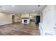 Open-concept living area with wood floors, a stone fireplace, and a view of the kitchen at 1304 Anchor Sw Ter, Atlanta, GA 30311