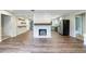 Open-concept living space showcasing a stone fireplace, wood floors, and a seamless flow to the kitchen at 1304 Anchor Sw Ter, Atlanta, GA 30311