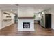 Stylish living room with wood floors, a stone fireplace, and an open layout with easy access to the kitchen at 1304 Anchor Sw Ter, Atlanta, GA 30311