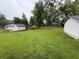 Expansive backyard with lush green grass and a detached garage at 25 Stonehedge Dr, Buford, GA 30518