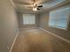 Bedroom featuring neutral paint, carpet, multiple windows for natural light, and ceiling fan at 25 Stonehedge Dr, Buford, GA 30518