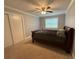 Bedroom with carpet, ceiling fan, and natural light from a window at 25 Stonehedge Dr, Buford, GA 30518