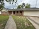 Well-kept single-story brick home featuring arched entryway and attached garage at 25 Stonehedge Dr, Buford, GA 30518