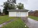 Detached one-car garage with white exterior and driveway at 25 Stonehedge Dr, Buford, GA 30518