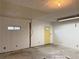 Spacious garage with yellow side door and small window at 25 Stonehedge Dr, Buford, GA 30518