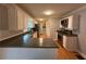 Updated kitchen features stainless steel appliances, white cabinetry, plenty of counter space and gorgeous hardwood floors at 25 Stonehedge Dr, Buford, GA 30518