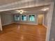 Living room with beautiful hardwood floors, plenty of windows for natural light, ceiling fan, and open doorway at 25 Stonehedge Dr, Buford, GA 30518