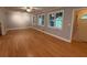 Open-concept living area with hardwood floors, natural light, and view of the front door and windows at 25 Stonehedge Dr, Buford, GA 30518