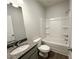 Bathroom features granite counters, shower-tub, framed mirror and wood-look floors at 5295 Greenway Dr, Villa Rica, GA 30180