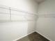 Walk-in closet with installed white wire shelving and neutral carpet flooring at 5295 Greenway Dr, Villa Rica, GA 30180
