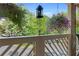 Charming balcony featuring hanging flower baskets and a view of lush green trees in a well-kept area at 690 Mcgill Ne Pl, Atlanta, GA 30312