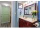 Bathroom with vanity, mirror, and view to the laundry area at 690 Mcgill Ne Pl, Atlanta, GA 30312