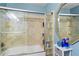 Bright bathroom showcasing glass block detail, tiled shower with glass door, vanity with mirror, and pale blue walls at 690 Mcgill Ne Pl, Atlanta, GA 30312