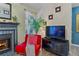 Comfortable living room featuring a fireplace, vibrant accent chair, and a well-placed TV for cozy viewing at 690 Mcgill Ne Pl, Atlanta, GA 30312