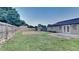 View of the backyard and fence with storage sheds and a lawn at 943 Colvin Dr, Locust Grove, GA 30248