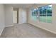 Bright bedroom featuring a large window and new carpeting at 943 Colvin Dr, Locust Grove, GA 30248