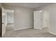 Bedroom featuring neutral walls, carpet, and doors leading to other rooms at 943 Colvin Dr, Locust Grove, GA 30248