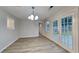 Bright dining area featuring new floors, patio access, and modern chandelier lighting at 943 Colvin Dr, Locust Grove, GA 30248