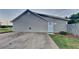 Exterior view of the home with a concrete driveway and siding at 943 Colvin Dr, Locust Grove, GA 30248