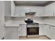 Modern kitchen with stainless steel appliances, white cabinets, and ample countertop space at 943 Colvin Dr, Locust Grove, GA 30248