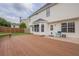 Backyard view highlighting the wooden deck, white exterior and well-maintained fenced in yard at 1130 Laurel Cove Dr, Snellville, GA 30078