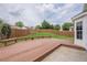 A spacious backyard features a wooden deck, a well-maintained lawn, and a privacy fence at 1130 Laurel Cove Dr, Snellville, GA 30078
