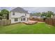 A very large grassy backyard with a wooden deck at 1130 Laurel Cove Dr, Snellville, GA 30078