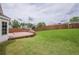 Wooden deck with built-in benches in grassy backyard at 1130 Laurel Cove Dr, Snellville, GA 30078