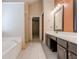 Spacious bathroom boasts double vanity, soaking tub, tile floor and access to walk-in closet at 1130 Laurel Cove Dr, Snellville, GA 30078