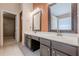 Bathroom featuring dual sinks, vanity area, updated lighting, and tile flooring at 1130 Laurel Cove Dr, Snellville, GA 30078