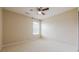 A neutral bedroom with a ceiling fan and a window at 1130 Laurel Cove Dr, Snellville, GA 30078