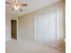 Bedroom featuring neutral walls, carpet floors, a ceiling fan, closet, and doors at 1130 Laurel Cove Dr, Snellville, GA 30078