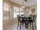 Bright dining area features a square table, 4 chairs, and natural light from three windows at 1130 Laurel Cove Dr, Snellville, GA 30078