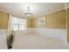 Dining room with neutral walls, classic wainscoting, modern lighting, and carpet flooring at 1130 Laurel Cove Dr, Snellville, GA 30078