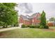 Beautiful two-story brick house showcases a well-kept lawn, garage, and traditional design elements at 1130 Laurel Cove Dr, Snellville, GA 30078