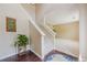 Open foyer with wooden floors, staircase with white banister, leading into carpeted living area at 1130 Laurel Cove Dr, Snellville, GA 30078