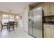 Kitchen area with stainless refrigerator, dining table and chairs, and sunlit breakfast nook at 1130 Laurel Cove Dr, Snellville, GA 30078
