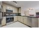 Modern kitchen with stainless steel appliances, tile backsplash, and ample counter space at 1130 Laurel Cove Dr, Snellville, GA 30078