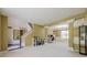 Open-concept living space featuring neutral carpeting, staircase, and dining space with large windows at 1130 Laurel Cove Dr, Snellville, GA 30078