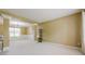 Spacious living room with neutral carpet, stylish chandelier, and an abundance of natural light at 1130 Laurel Cove Dr, Snellville, GA 30078