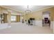 Open-concept living space featuring neutral carpet, modern lighting, and versatile dining area with a dark hardwood floor at 1130 Laurel Cove Dr, Snellville, GA 30078
