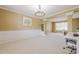 Spacious living room with carpet, natural light, and decorative molding accents throughout the space at 1130 Laurel Cove Dr, Snellville, GA 30078
